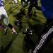 Players and coaches run over tossed helmets in a brawl following the concluding of the game between Huron and Pioneer High Schools Friday. Daniel Brenner I AnnArbor.com